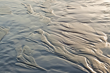 textures in the sand from water flow