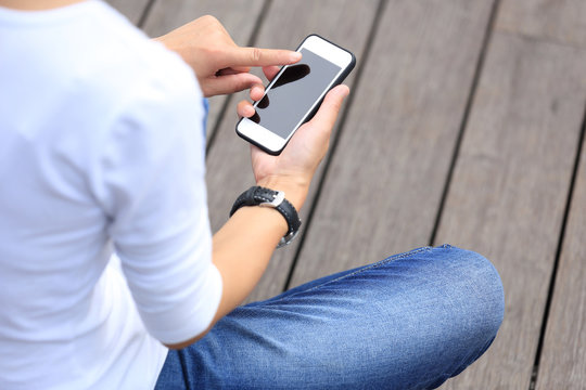 Young Woman Skateboarder Use Smartphone Sit On Skateboard