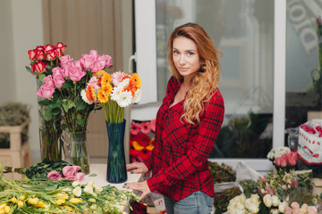 Beautiful female florist in flower shop