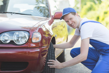 Automechaniker prüft Reifen