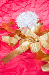 image of gold bow with white bow