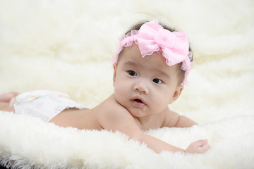 Baby sitting on a soft cloth in the living room