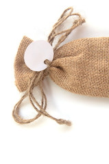 burlap sack with tag on white,souvenir in wedding