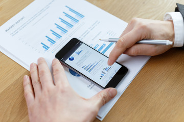 businessman checking financial reports on table
