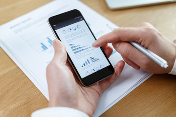 businessman checking financial reports on table