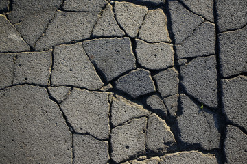 Grey cracked asphalt