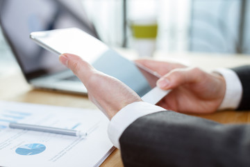 businessman checking financial reports on table