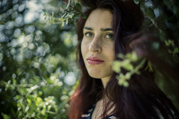 romantic girl with branches of a tree in a park