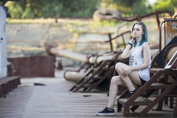 Blue haired girl walk on Old rusty forsaken barges