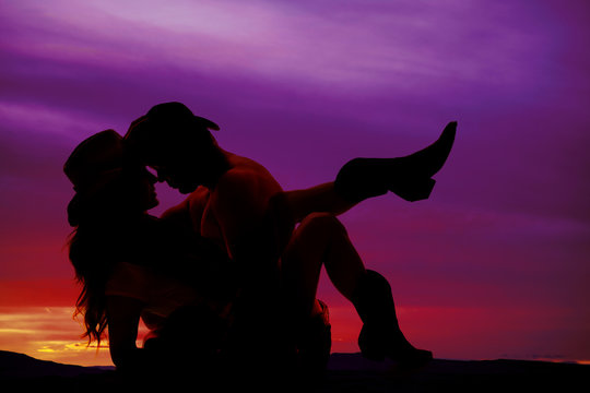 silhouette of cowboy and cowgirl faces close