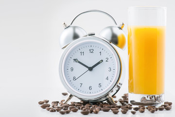 Alarm clock and fresh juice on the surface
