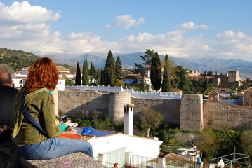 Fototapeta na wymiar Tourists looking towards the Palace of Alhambra, Granada.