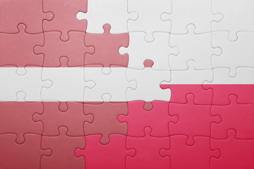 puzzle with the national flag of latvia and poland