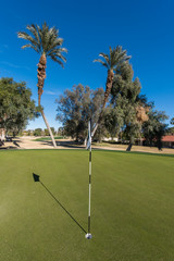Fototapeta premium Golf course green with flag in hole