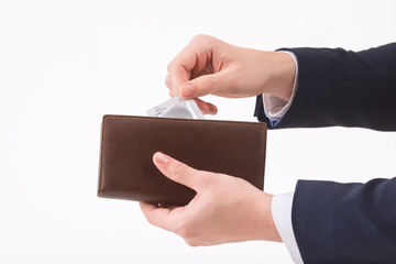 Male hand putting condom into the wallet.