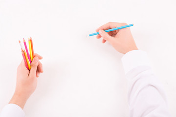 Male hands with colored pencils.