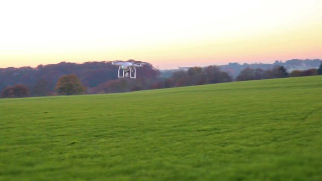 Modern RC UAV Drone / Quadcopter with camera flying on a clear sky