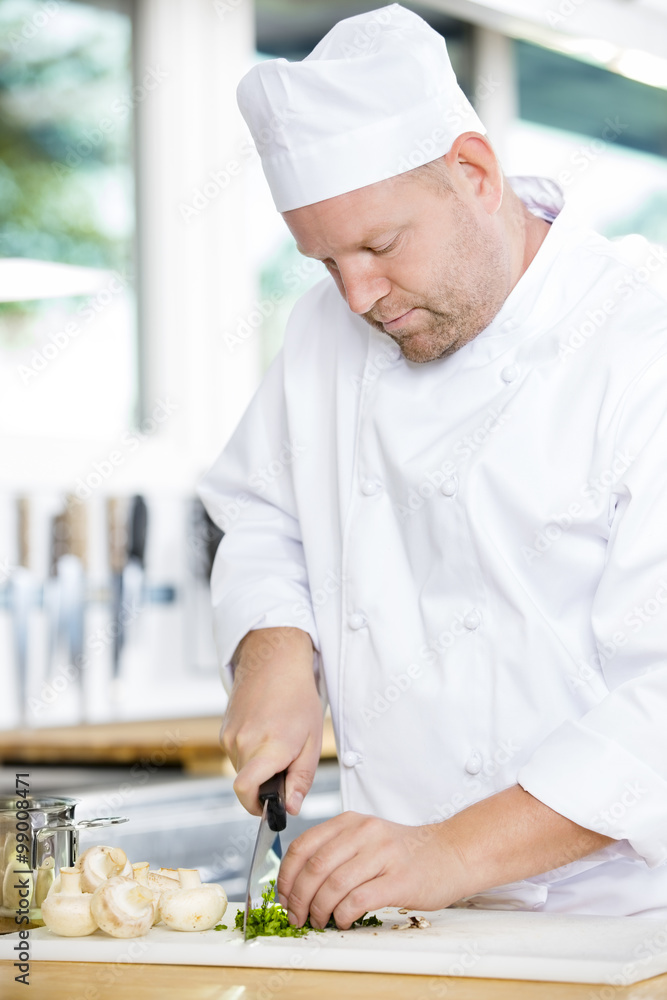 Wall mural professional chef preparing vegetables to a healthy dish