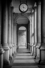 Old clock, and stone columns in Karlovy Vary, Czech Republic