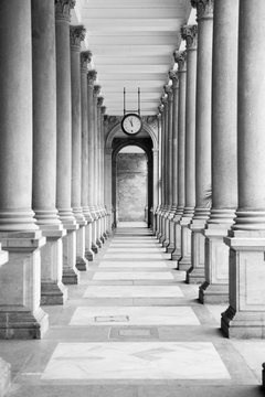 Old clock, and stone columns in Karlovy Vary, Czech Republic