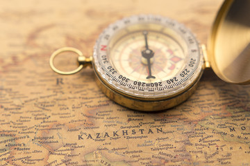 Fototapeta na wymiar Old compass on vintage map selective focus on Kazakhstan