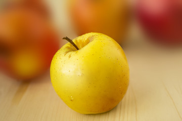 Delicious and fresh apple on wood and blur background