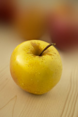 Delicious and fresh apple on wood and blur background