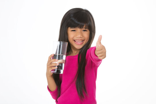young girl holding a glass of water