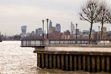 A lookout on the Thames Path, a walk along the river Thames in London. The view is of the London financial skyline and a bend in the river.