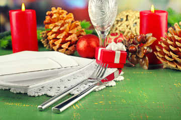 Table appointments with present box and Christmas decoration background