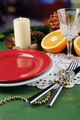 Table appointments with pieces of orange and Christmas decoration background