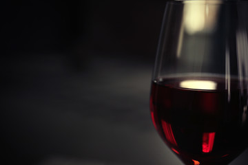 Glass of red wine on blurred background