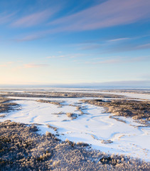 Forest river during cold winter day, top view