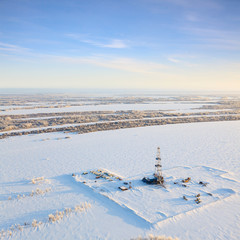 Winter terrain with oil rig in winter, top view