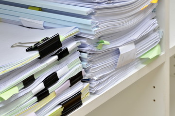 Documents on bookshelf at workplace