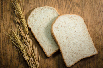 sliced grain bread on wood texture background