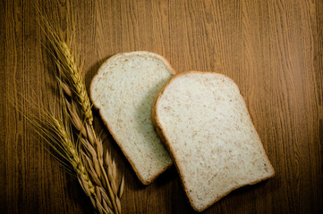sliced grain bread on wood texture background