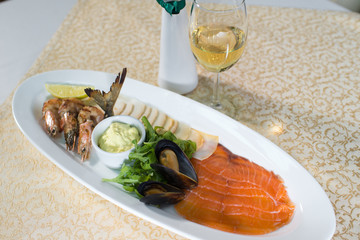 dish with seafood and white sause on the table in the restaurant