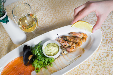 dish with seafood and white sause on the table in the restaurant