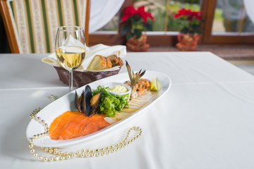 dish with seafood and white sause on the table in the restaurant