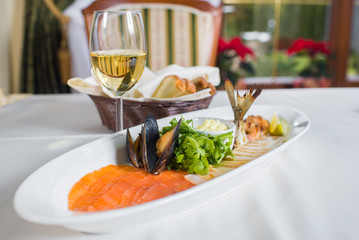 dish with seafood and white sause on the table in the restaurant