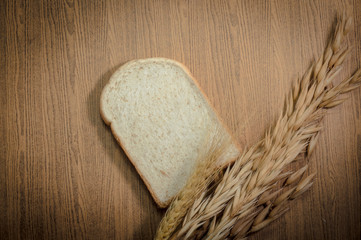 sliced grain bread on wood texture background