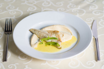 dietary dish of white fish in sauce