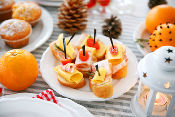 Tasty canapes for festive dinner. Christmas table setting