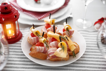 Tasty canapes for festive dinner. Christmas table setting