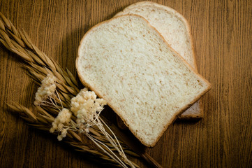 sliced grain bread on wood texture background