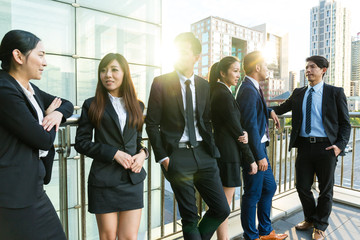 Group of business people talking outside office