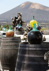 Gordijnen Barrels and  big bottles with grape wine - malvasia.  Lanzarote, Spain © wjarek