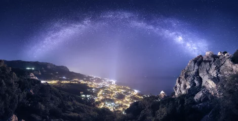 Deurstickers Beautiful night landscape with Milky Way against city lights © den-belitsky