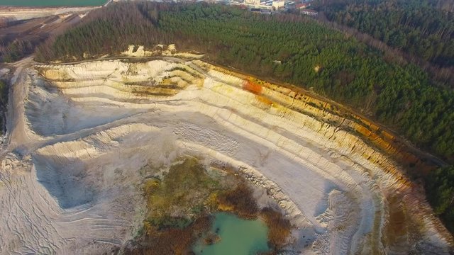 Camera flight over industrial zone Chlumcany kaolin quarry and ceramics factory near Pilsen in Czech Republic. 